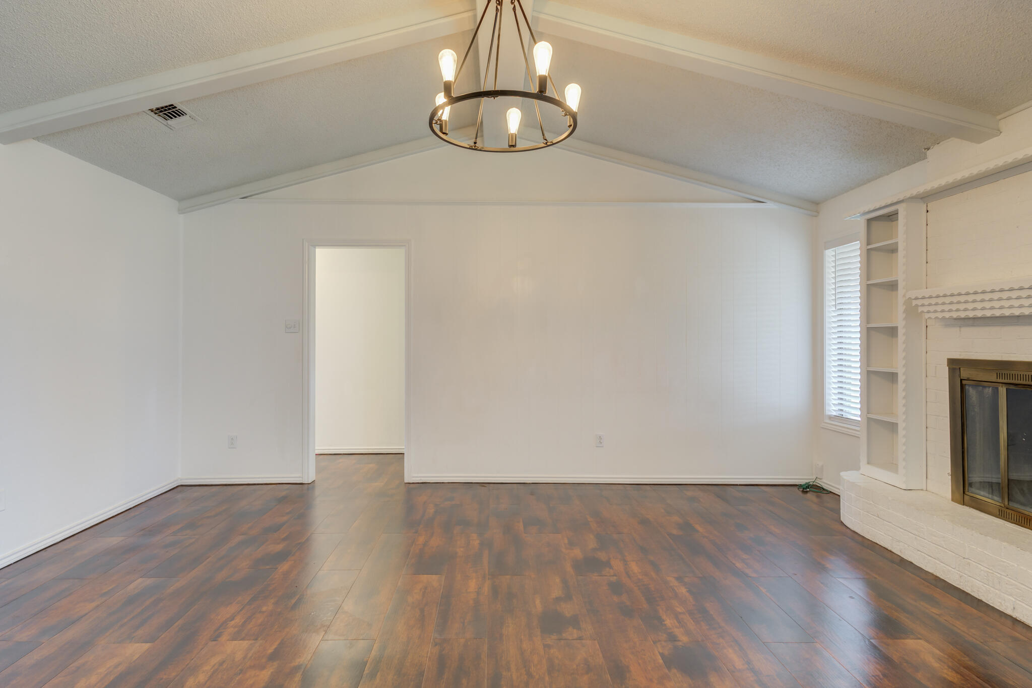 4813 73rd Street Lubbock, TX 79424 - Photo 15 of 37 a view of empty room with wooden floor and fireplace