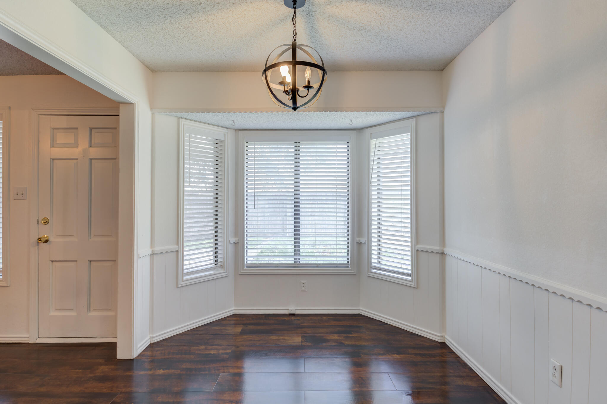 4813 73rd Street Lubbock, TX 79424 - Photo 17 of 37 a view of an empty room with wooden floor and a window