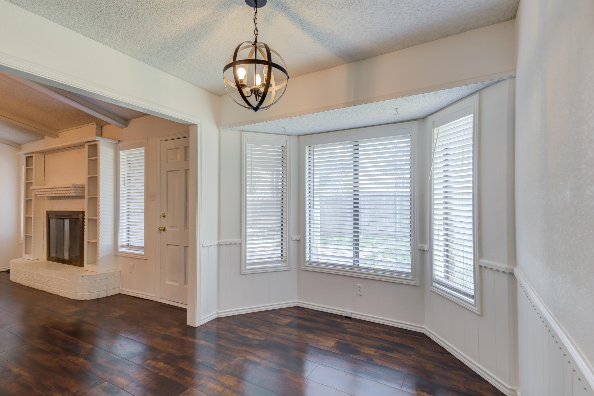 4813 73rd Street Lubbock, TX 79424 - Photo 18 of 37 a view of an empty room with wooden floor and a window