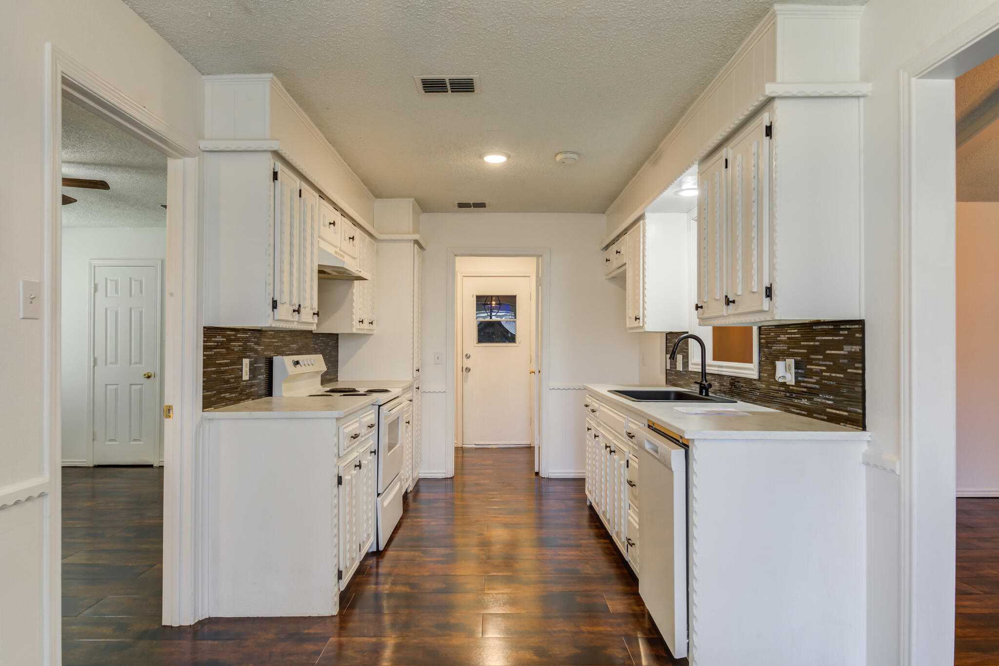 4813 73rd Street Lubbock, TX 79424 - Photo 20 of 37 a kitchen with stainless steel appliances granite countertop a stove and a sink