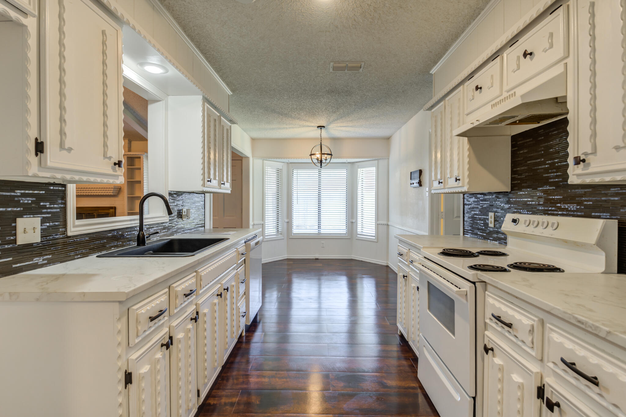 4813 73rd Street Lubbock, TX 79424 - Photo 23 of 37 a kitchen with stainless steel appliances granite countertop a sink stove and cabinets