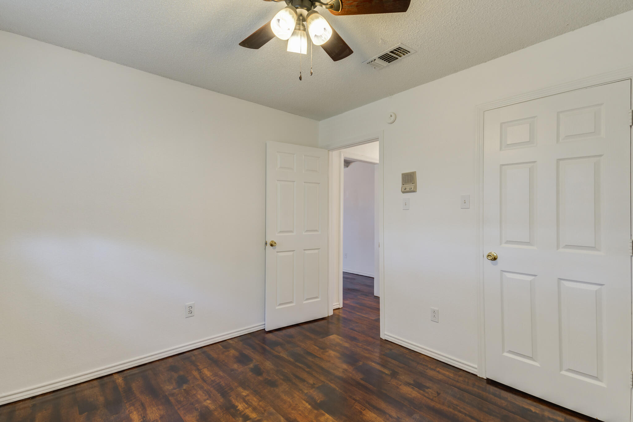 4813 73rd Street Lubbock, TX 79424 - Photo 28 of 37 a view of an empty room with wooden floor