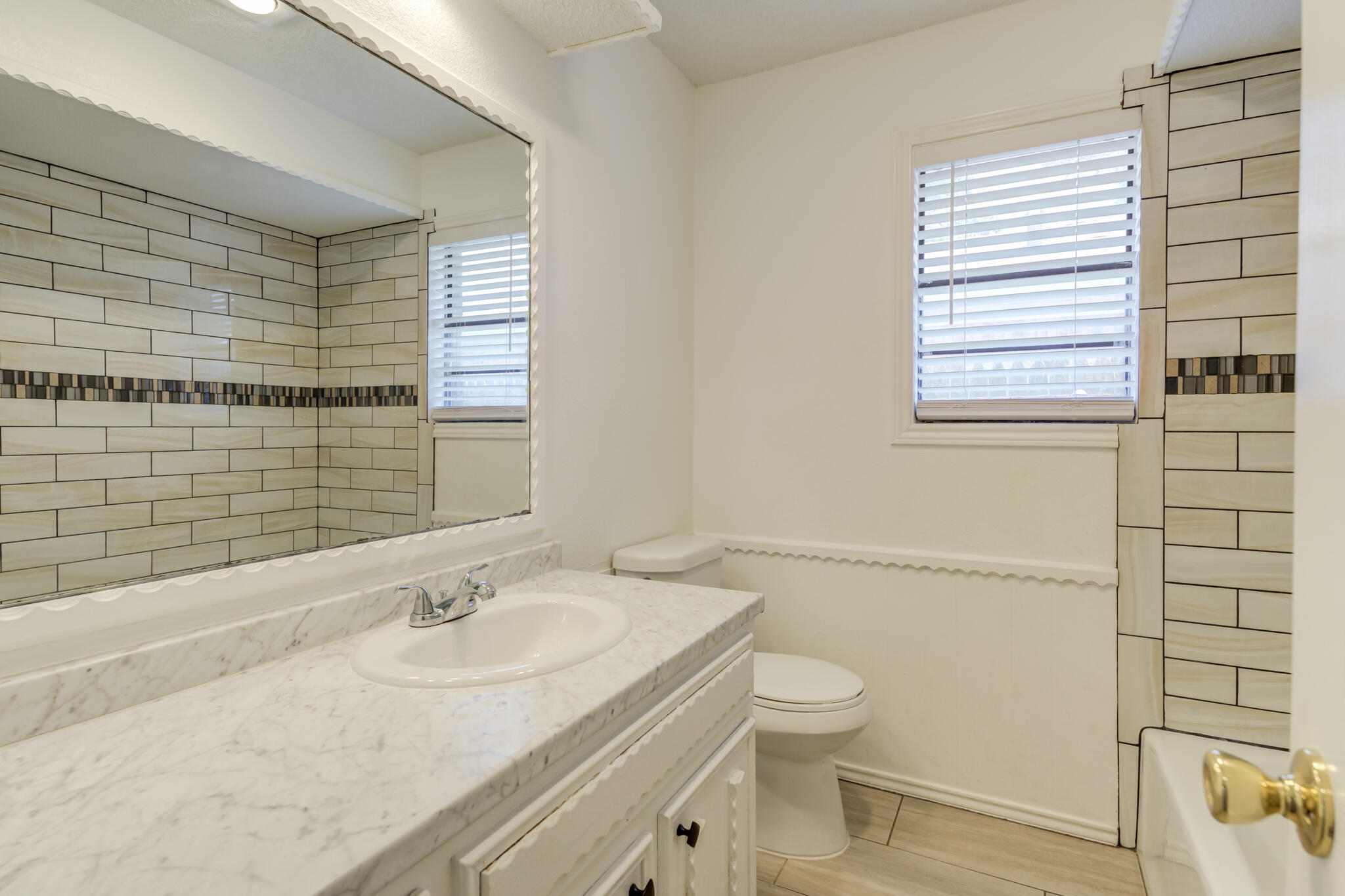 4813 73rd Street Lubbock, TX 79424 - Photo 30 of 37 a bathroom with a granite countertop sink toilet and shower