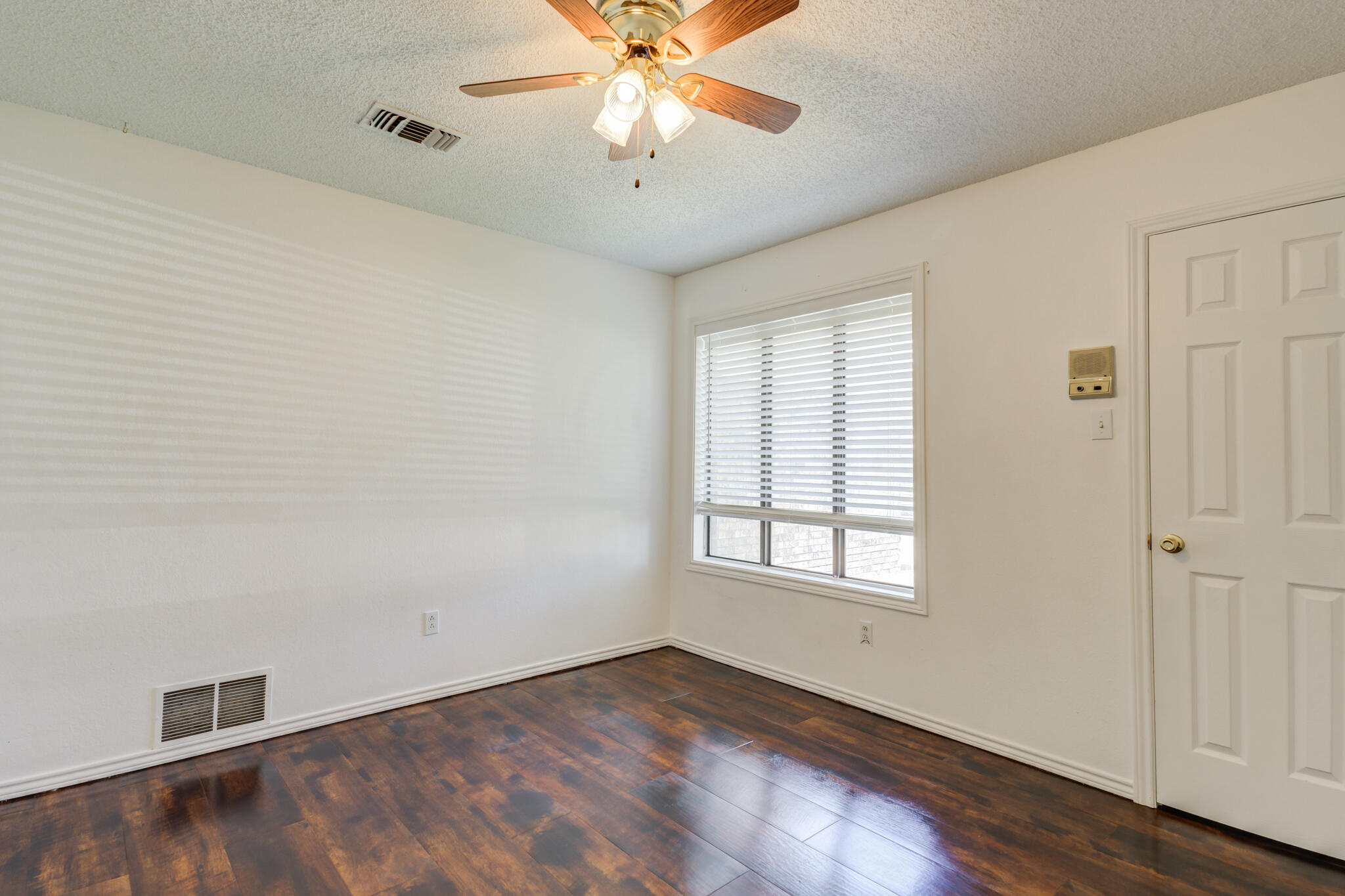 4813 73rd Street Lubbock, TX 79424 - Photo 33 of 37 a view of an empty room with window and wooden floor