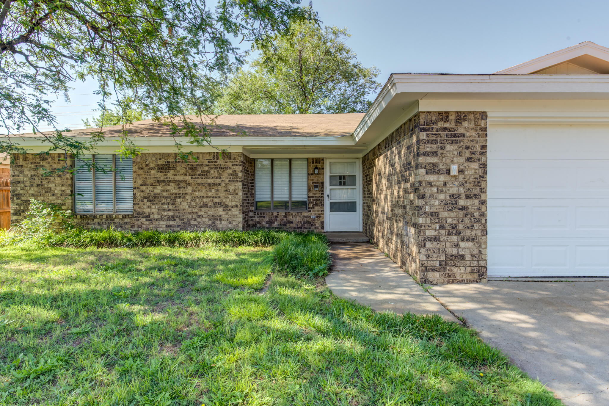 4813 73rd Street Lubbock, TX 79424 - Photo 4 of 37 a front view of a house with garden