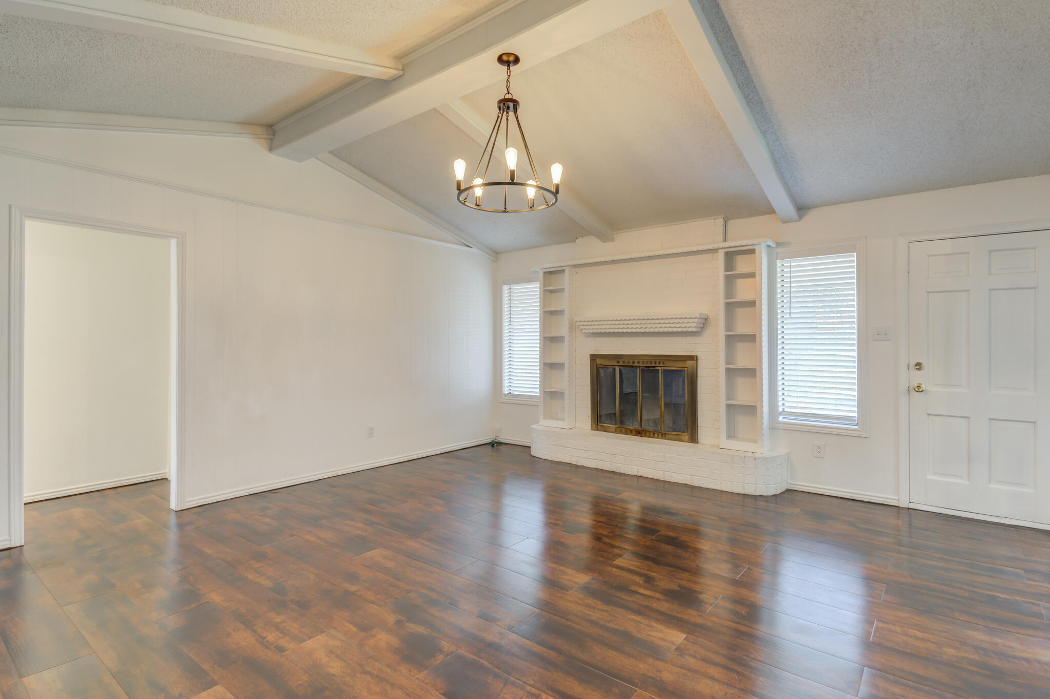 4813 73rd Street Lubbock, TX 79424 - Photo 8 of 37 a view of an empty room with wooden floor fireplace and a window