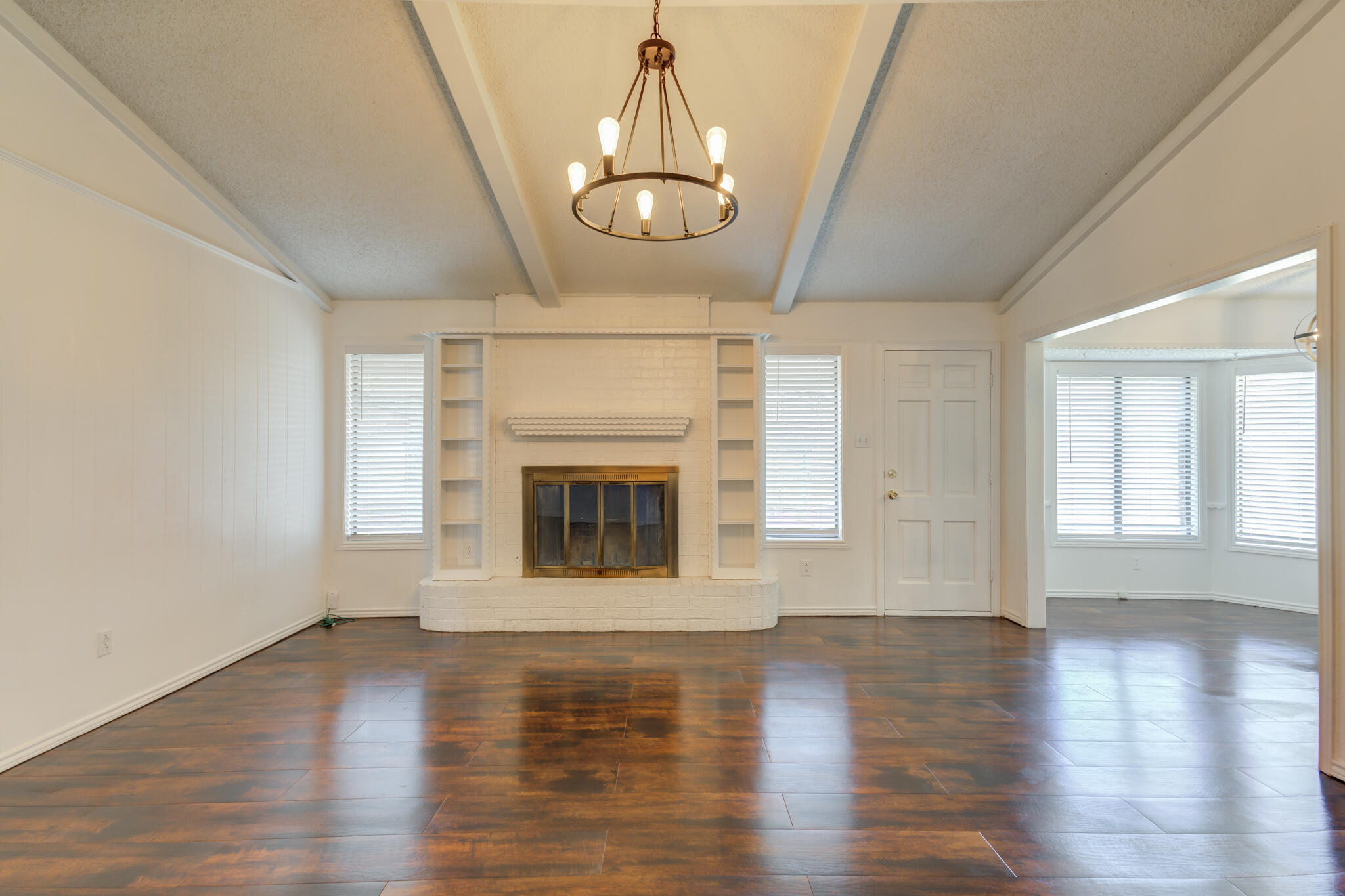 4813 73rd Street Lubbock, TX 79424 - Photo 9 of 37 a view of an empty room with wooden floor fireplace and a window