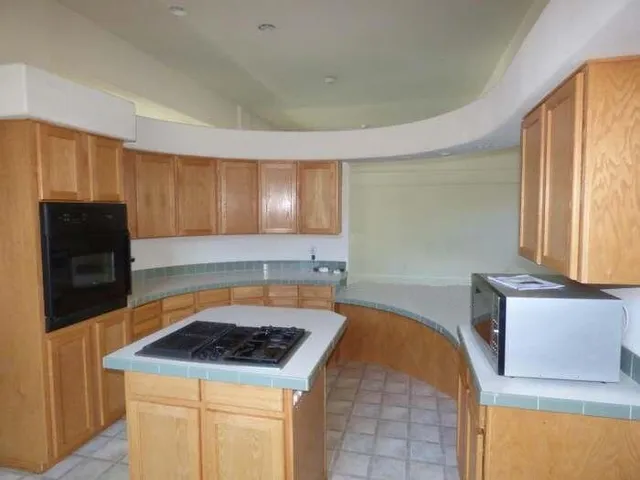 a kitchen with a stove a sink and a microwave