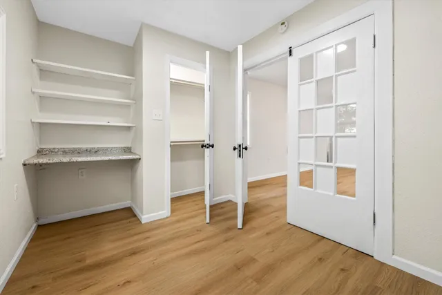 a view of a room with wooden floor and a cabinet