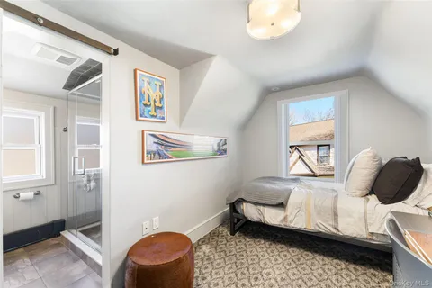 a bedroom with a bed and a painting on the wall