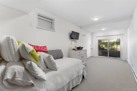 a bedroom with a bed and a large window