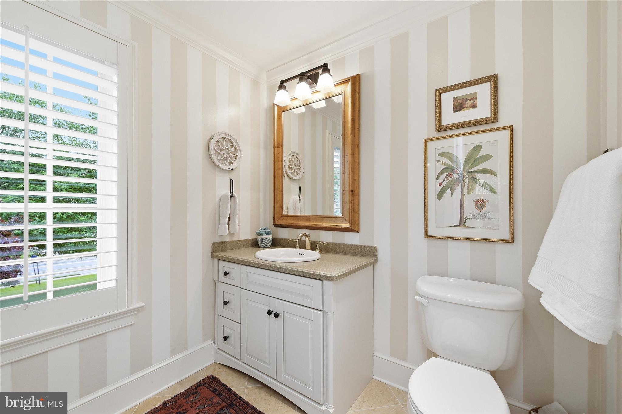 3824 Military Road Arlington, VA 22207 - Photo 22 of 54 a bathroom with a granite countertop toilet a sink and a mirror