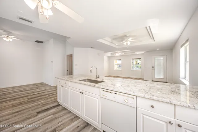 a bathroom with a granite countertop sink and mirror