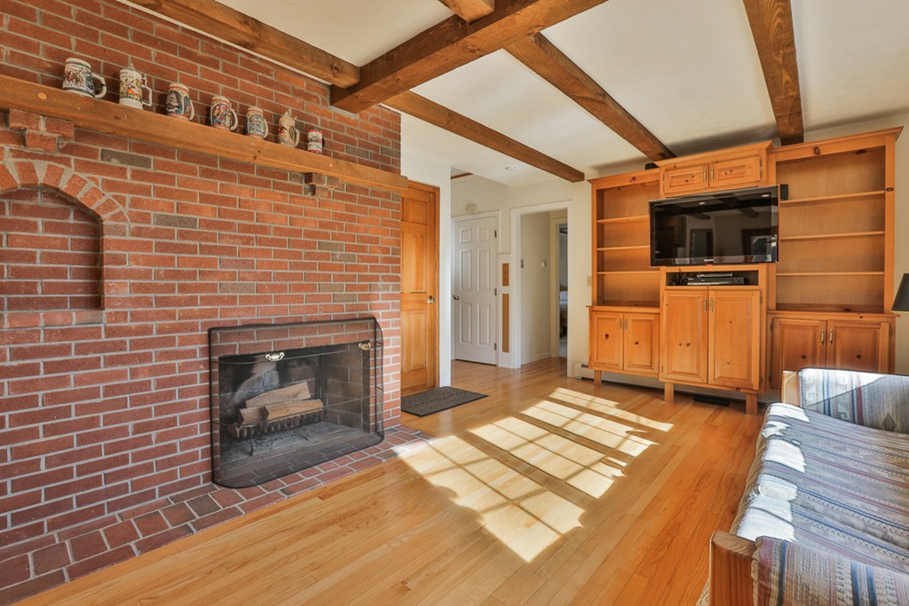 61 C Highland Road Boxford, MA 01921 - Photo 5 of 30 a living room with stainless steel appliances wooden floor and fireplace