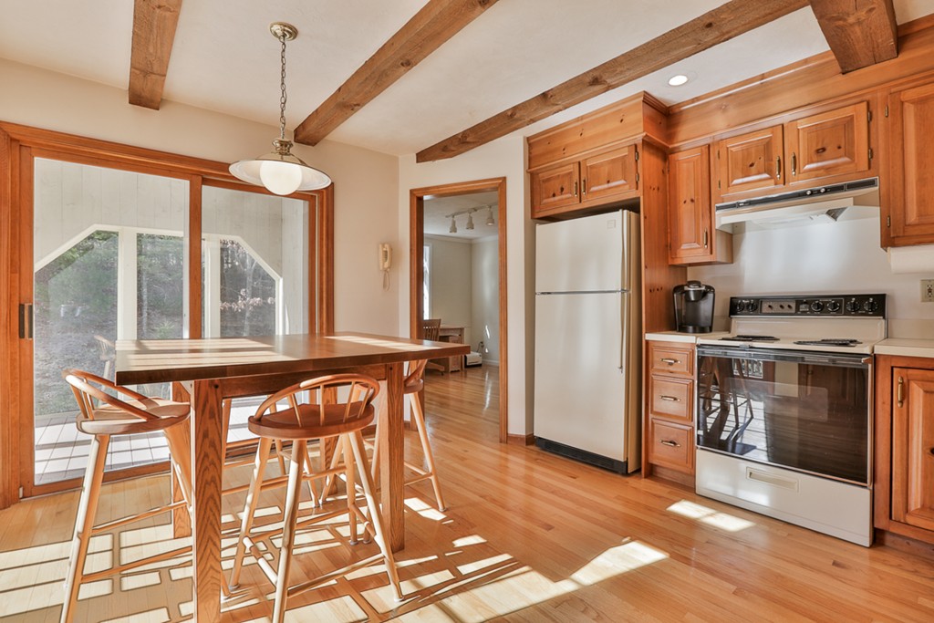 61 C Highland Road Boxford, MA 01921 - Photo 7 of 30 a kitchen with a refrigerator a stove and a wooden floor