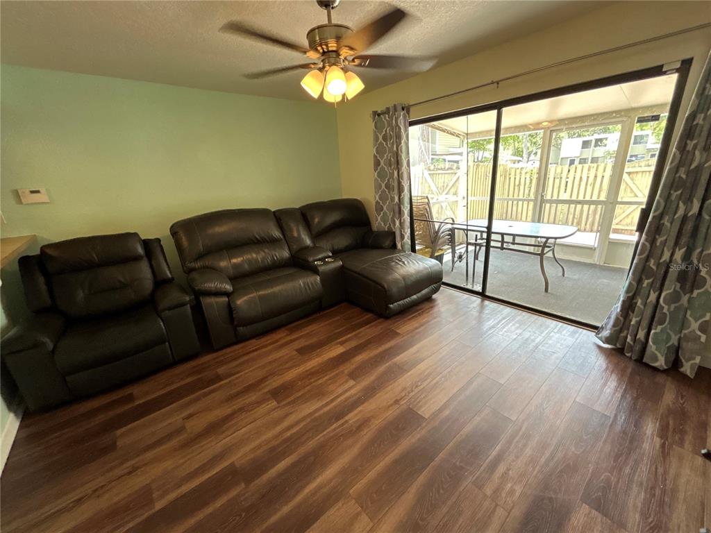 4912 25th Street West, Unit 102 Bradenton, FL 34207 - Photo 4 of 12 a living room with furniture and a large window