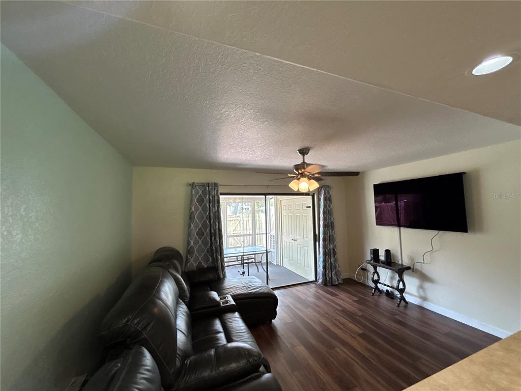 4912 25th Street West, Unit 102 Bradenton, FL 34207 - Photo 5 of 12 a living room with furniture and a flat screen tv