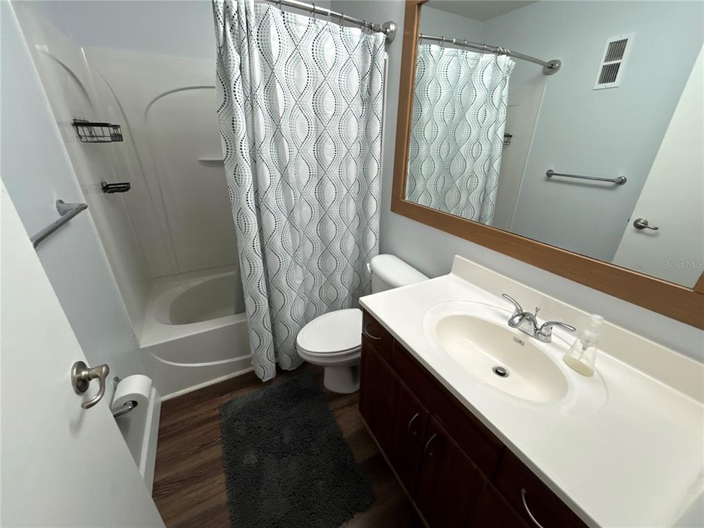 4912 25th Street West, Unit 102 Bradenton, FL 34207 - Photo 10 of 12 a bathroom with a sink a toilet and shower
