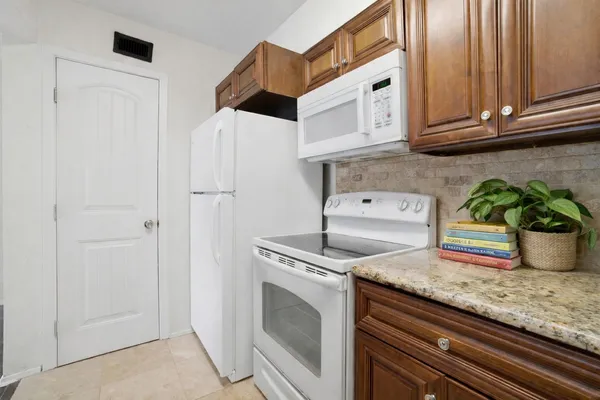 a kitchen with stainless steel appliances granite countertop a sink a stove and cabinets