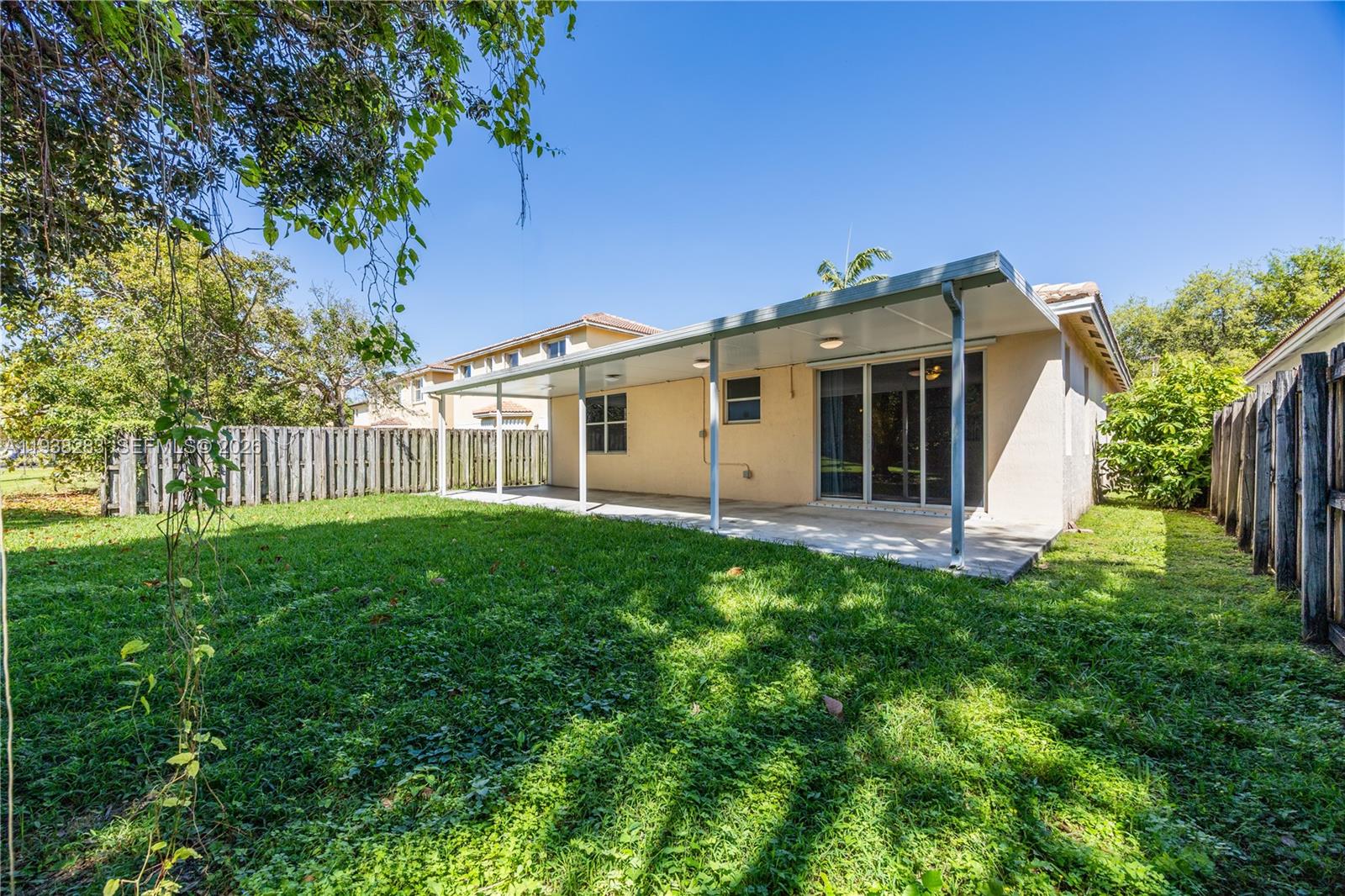 10770 Southwest 245th Street Homestead, FL 33032 - Photo 39 of 47 Open area behind leads to the vacant HOA common area.