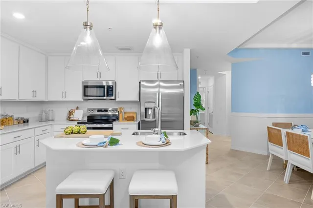 a kitchen that has a refrigerator and a sink