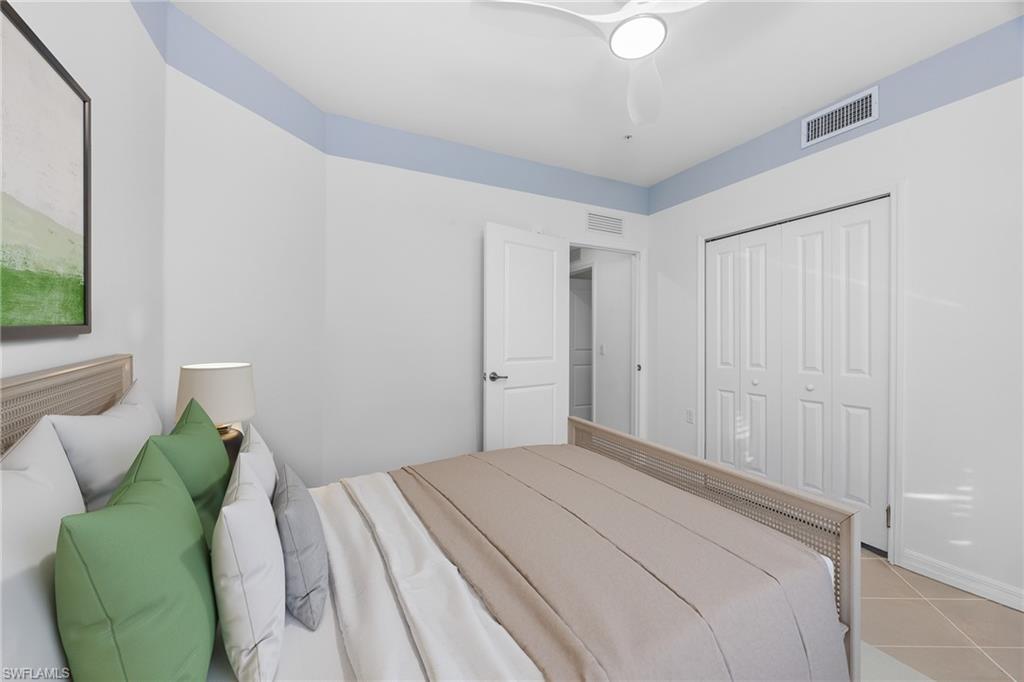 18461 Copperhead Drive, Unit 418 Lehigh Acres, FL 33936 - Photo 16 of 33 Bedroom featuring a closet, light tile patterned flooring, and ceiling fan