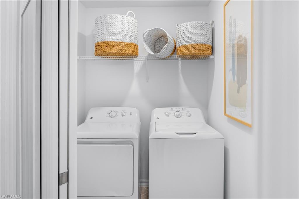 18461 Copperhead Drive, Unit 418 Lehigh Acres, FL 33936 - Photo 20 of 33 Laundry area with washing machine and dryer