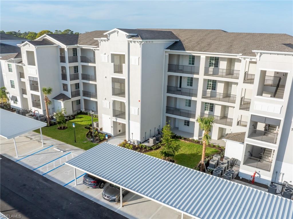 18461 Copperhead Drive, Unit 418 Lehigh Acres, FL 33936 - Photo 24 of 33 View of apartment building / complex with uncovered parking