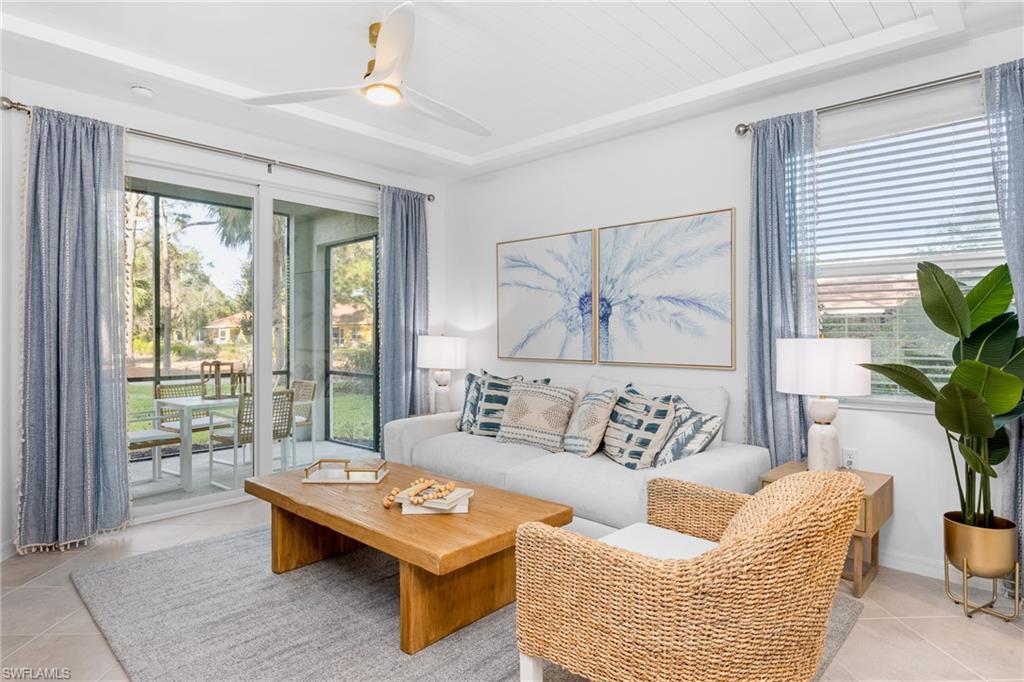 18461 Copperhead Drive, Unit 418 Lehigh Acres, FL 33936 - Photo 4 of 33 Living area featuring light tile patterned floors and a ceiling fan