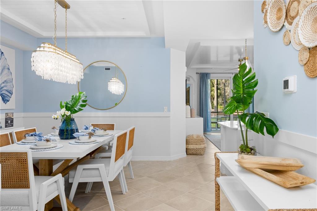 18461 Copperhead Drive, Unit 418 Lehigh Acres, FL 33936 - Photo 7 of 33 Tiled dining room with a chandelier and baseboards