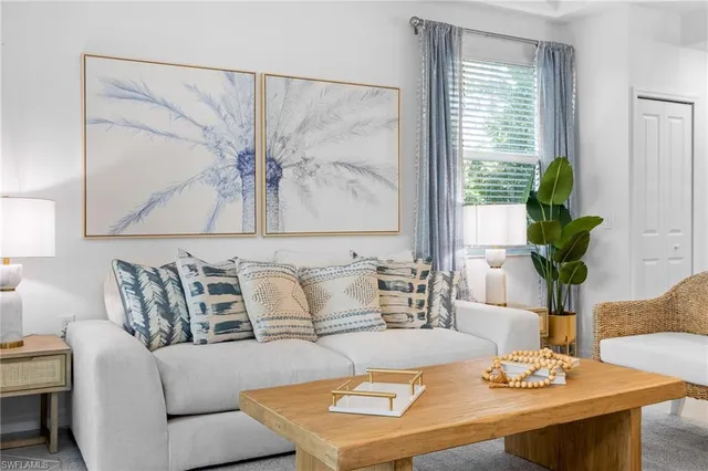 a living room with furniture and a potted plant