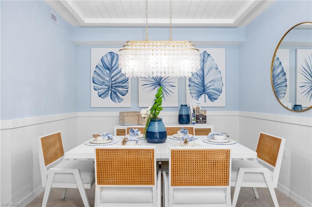 18461 Copperhead Drive, Unit 418 Lehigh Acres, FL 33936 - Photo 9 of 33 Dining room with a chandelier, tile patterned floors, and wooden ceiling