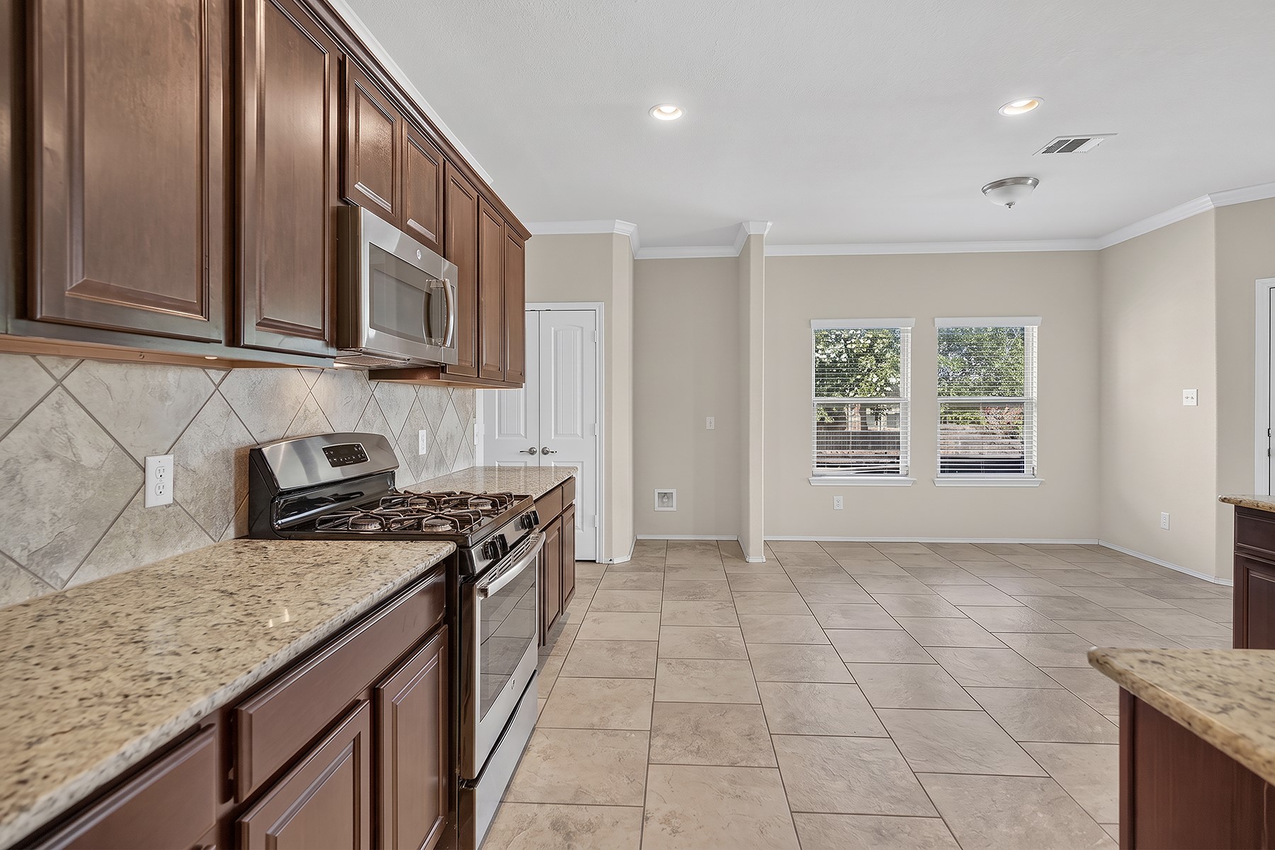 4601 Chestnut Meadows Bend Georgetown, TX 78626 - Photo 7 of 35 Culinary delights await in this modern kitchen with granite countertops and stainless steel appliances.