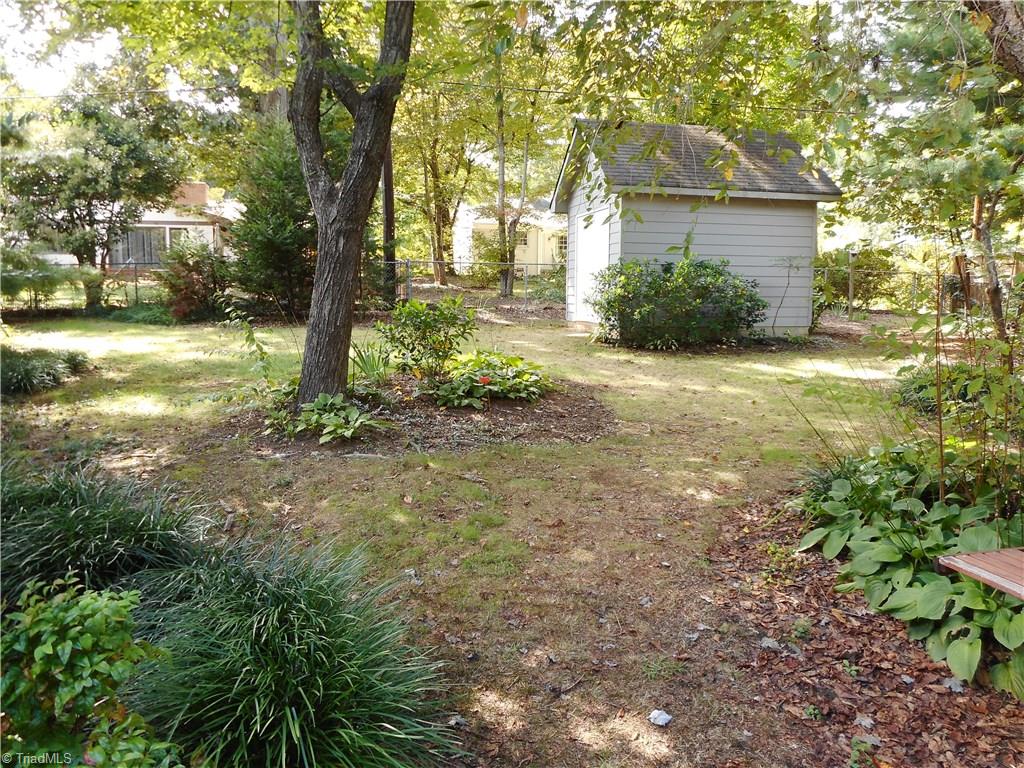 1607 Milan Road Greensboro, NC 27410 - Photo 20 of 22 Charming back yard with fence and storage building.