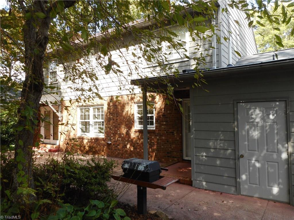 1607 Milan Road Greensboro, NC 27410 - Photo 21 of 22 Huge patio, built in grill, storage room and friends entrance.