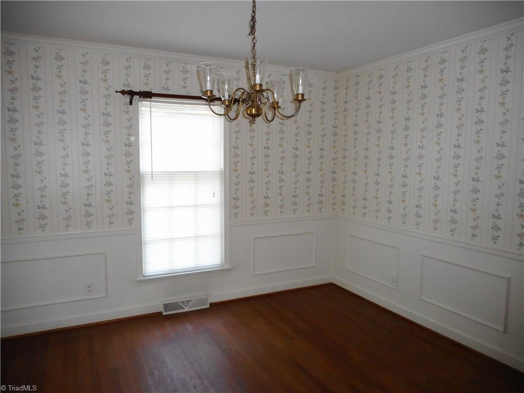 1607 Milan Road Greensboro, NC 27410 - Photo 4 of 22 Formal Dining room with wainscoting and wood floors