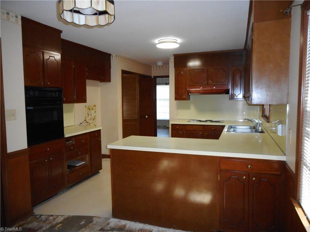 1607 Milan Road Greensboro, NC 27410 - Photo 6 of 22 Kitchen offers good space and needs updating. Double door pantry.