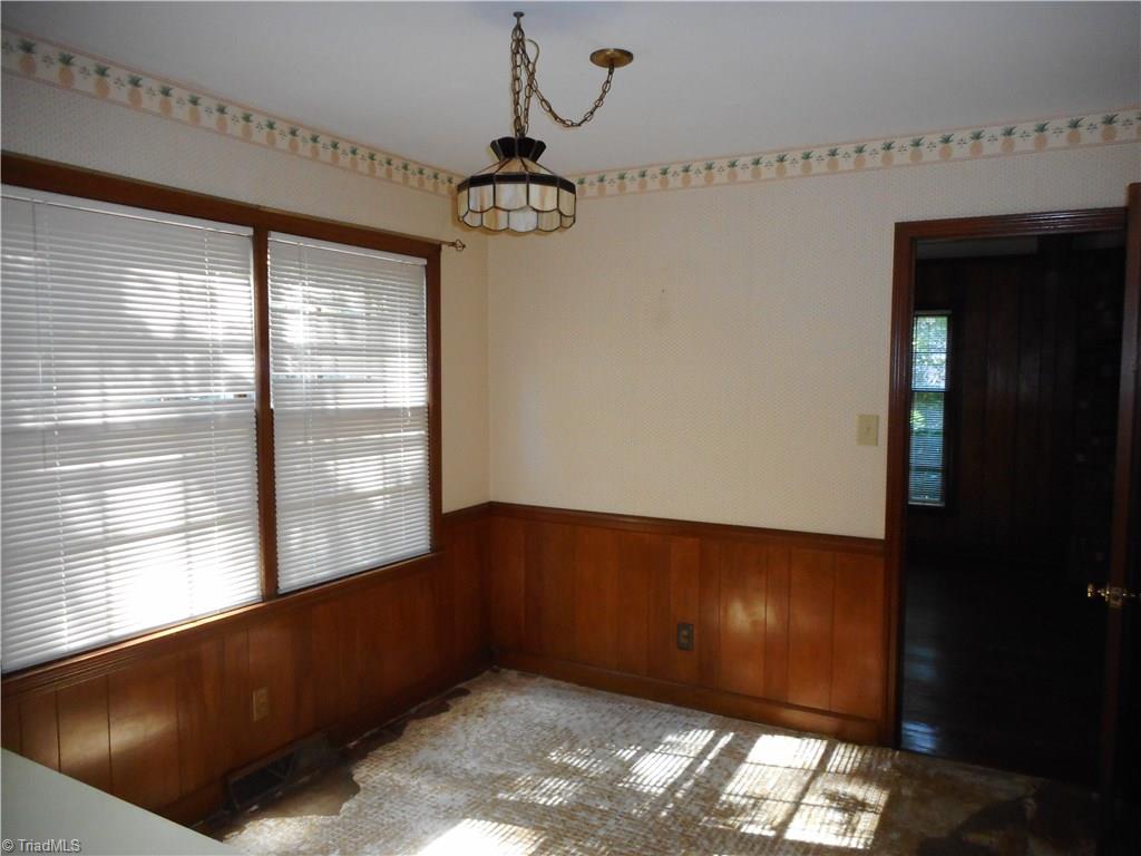 1607 Milan Road Greensboro, NC 27410 - Photo 7 of 22 Breakfast area has great views of the back yard and natural light. Needs a new floor covering.