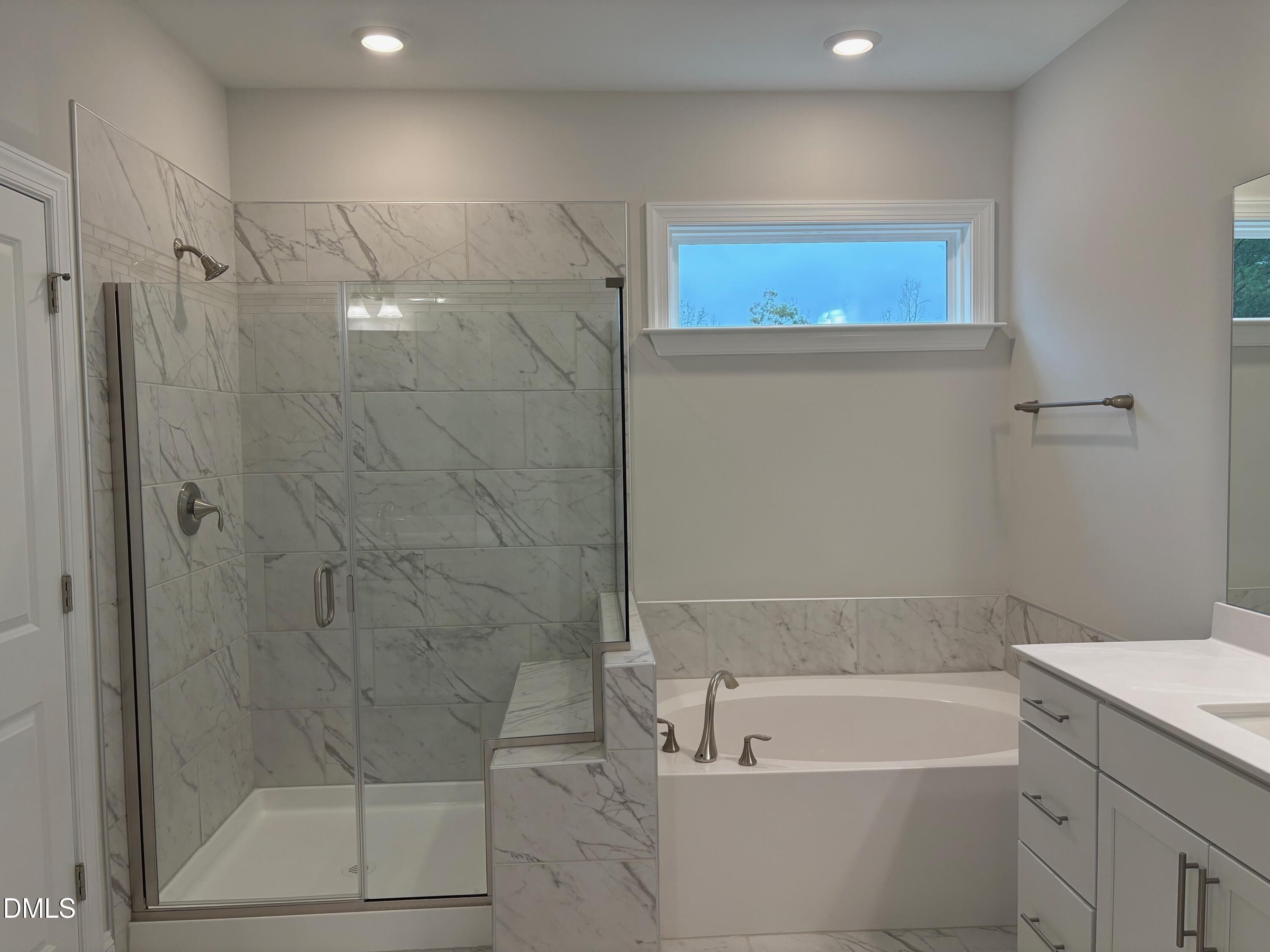 136 Corapeake Way Apex, NC 27539 - Photo 13 of 27 a bathroom with a shower a bathtub and a shower