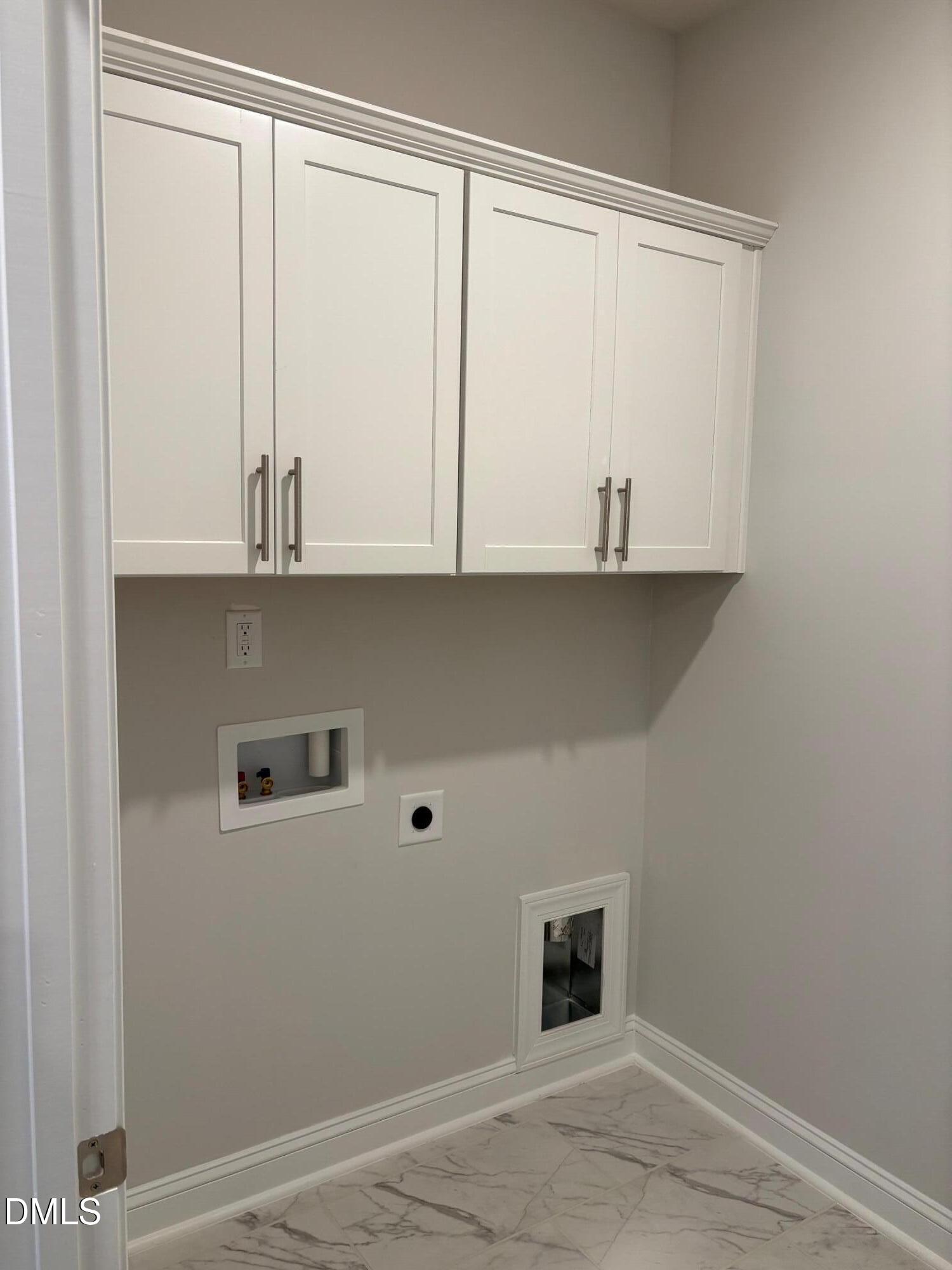 136 Corapeake Way Apex, NC 27539 - Photo 10 of 27 a kitchen with a white cabinets and a wooden floor