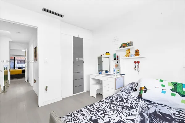 a bedroom with a bed and a desk