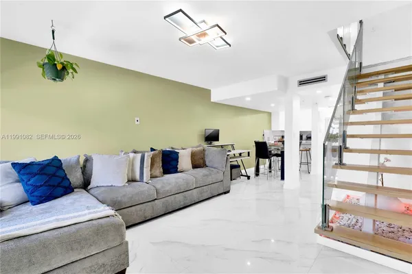 a living room with furniture and wooden floor