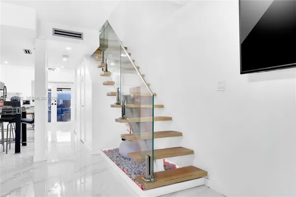 a view of entryway and hall with wooden floor