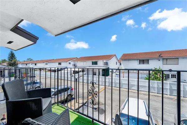 a view of a balcony with chairs