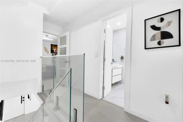 a living room with furniture and view of bathroom