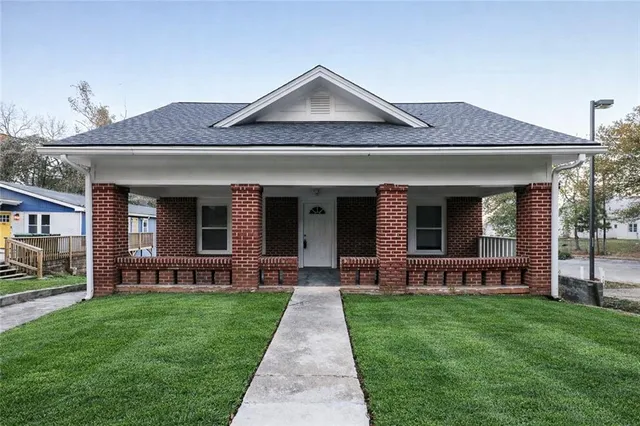 a front view of a house with garden