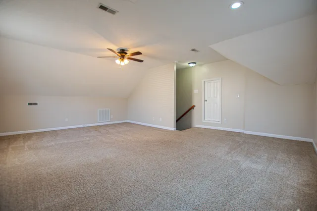 a view of a big room with a ceiling fan and chandelier fan