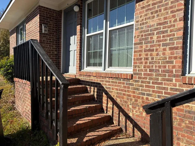 a view of balcony with wooden floor and white walls