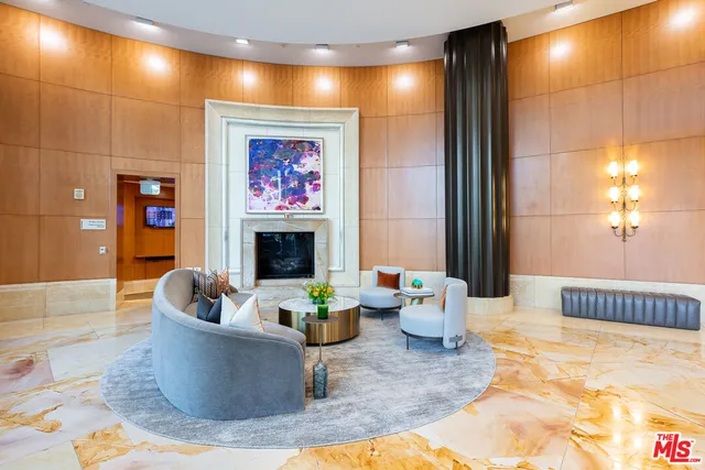 a living room with fireplace furniture and a potted plant
