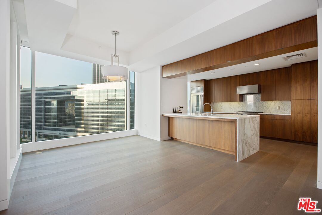 1 West Century Drive, Unit 8D Los Angeles, CA 90067 - Photo 5 of 12 a view of kitchen with granite countertop stove top oven and cabinets